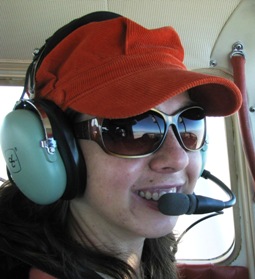 Reya in airplane cockpit with headset